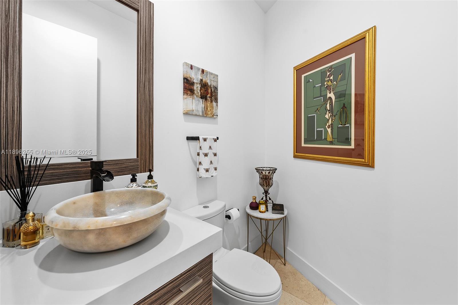 8923 Ludlam Road Pinecrest, FL 33156 - Photo 55 of 69 a bathroom with a toilet a sink and mirror