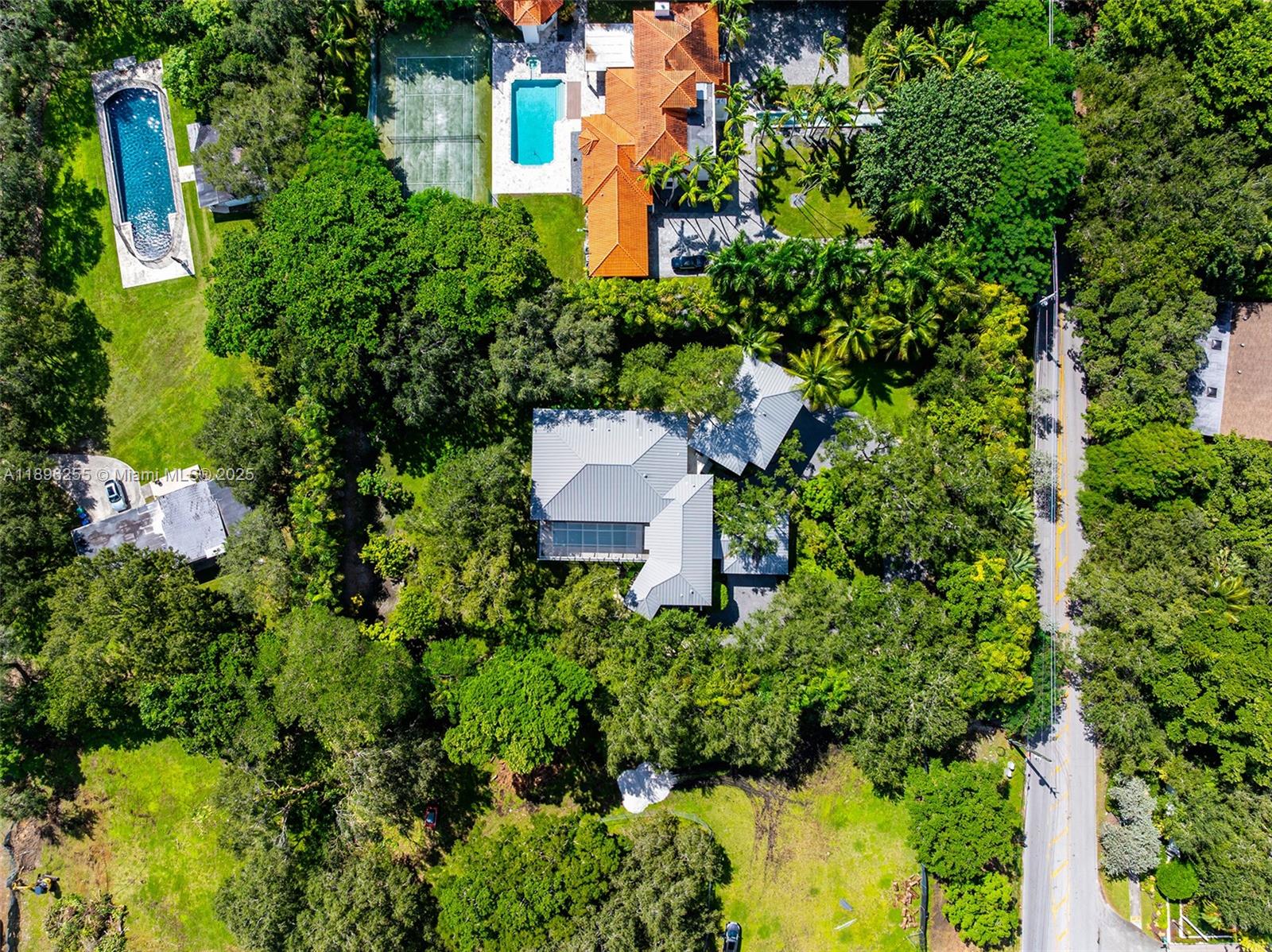 8923 Ludlam Road Pinecrest, FL 33156 - Photo 59 of 69 an aerial view of a house with swimming pool and garden