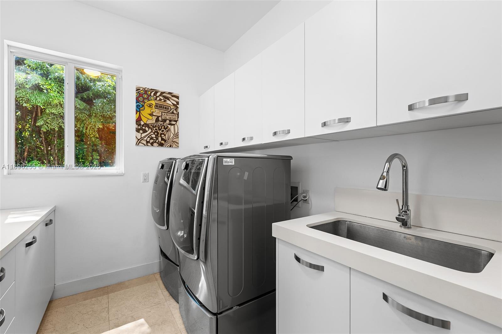 8923 Ludlam Road Pinecrest, FL 33156 - Photo 68 of 69 a kitchen with a refrigerator and a sink