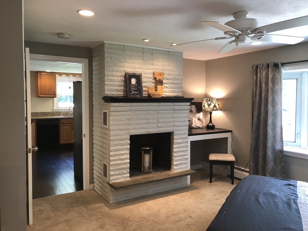 57 Middle Road Amesbury, MA 01913 - Photo 8 of 20 a living room with furniture and a fireplace