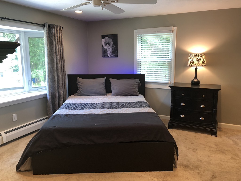 57 Middle Road Amesbury, MA 01913 - Photo 9 of 20 a bed sitting in a bedroom next to a window