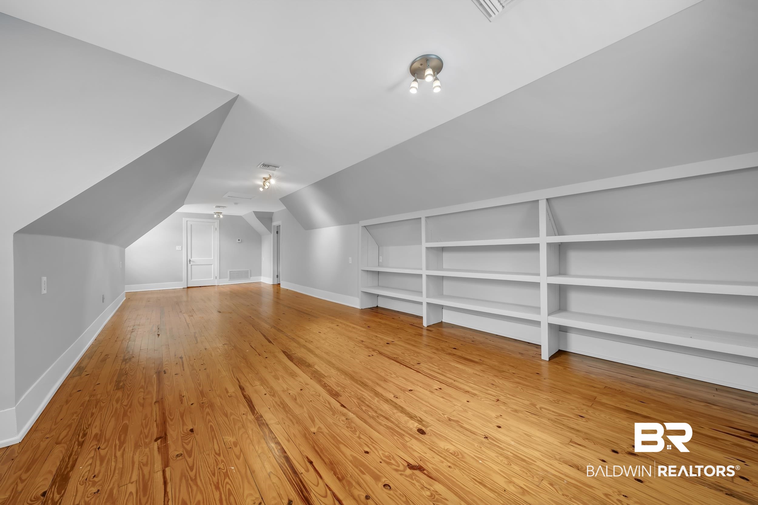 43199 Pine Grove Road Bay Minette, AL 36507 - Photo 70 of 71 Spacious room with wood-finish flooring, sloped ceilings, recessed lighting, and extensive built-in shelving