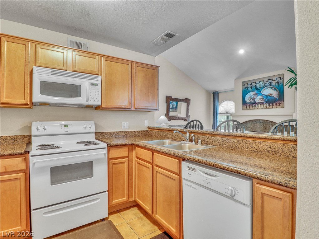 3145 East Flamingo Road, Unit 2129 Las Vegas, NV 89121 - Photo 8 of 43 A well-equipped kitchen boasts practical counter space and an open-concept pass-through.