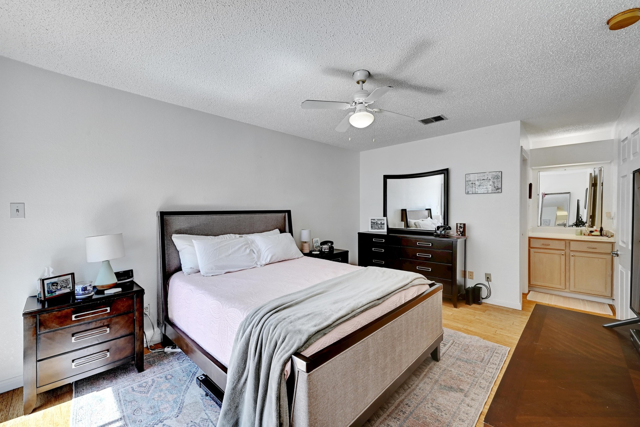 7635 Guadalupe Street, Unit 1002 Austin, TX 78752 - Photo 16 of 27 a bedroom with a bed and a view of bedroom