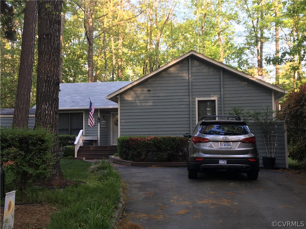 a view of a car in front of a house with garage