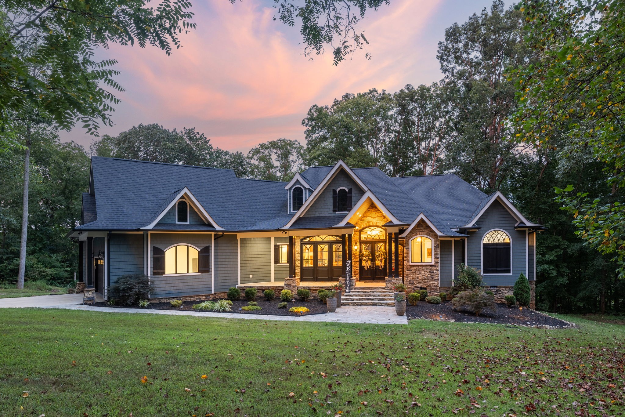 74 Pine Lake Road Summertown, TN 38483 - Photo 1 of 90 a front view of a house with a garden and porch