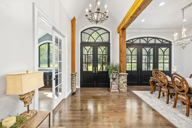 a living room with furniture a fireplace and a large window