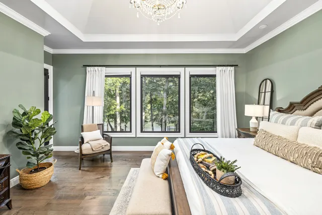 a view of a dining room with furniture large windows and wooden floor