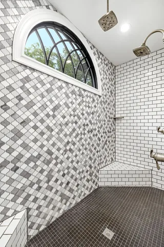 a bedroom with a large bed and a flat tv screen on dresser