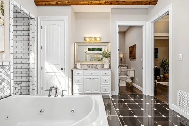 a bathroom with a toilet sink and mirror
