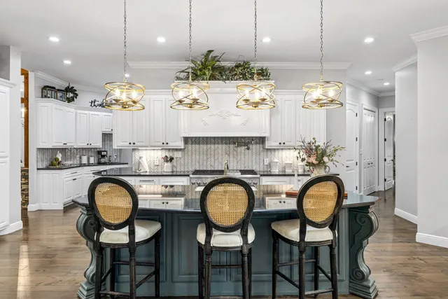 an aerial view of residential house with outdoor space and a lake view