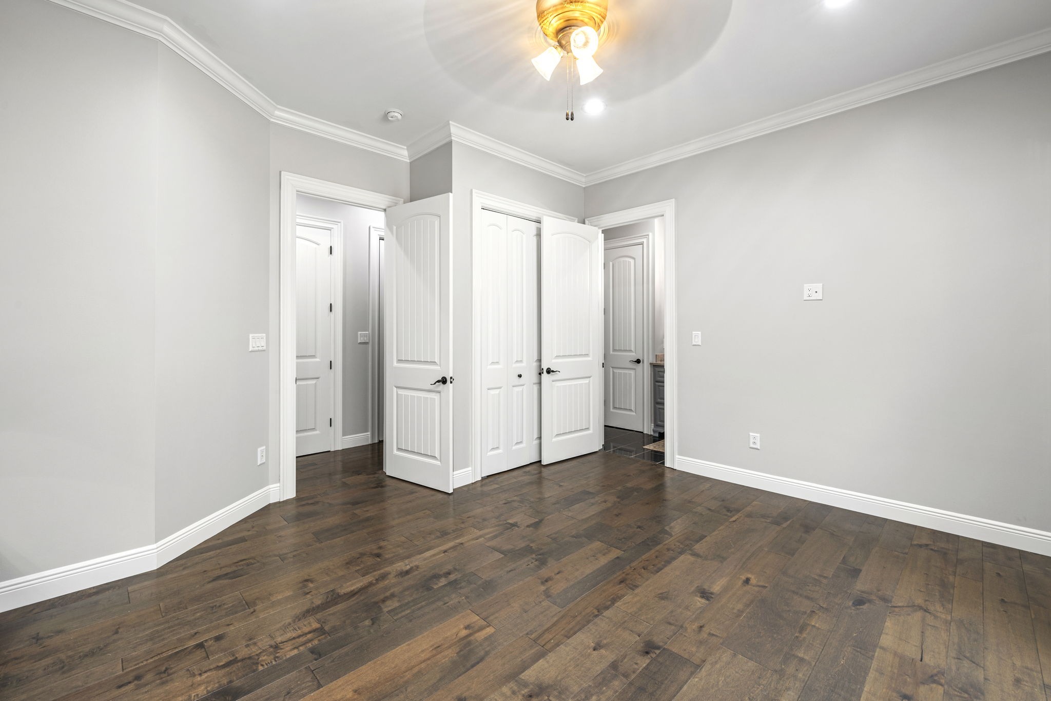 74 Pine Lake Road Summertown, TN 38483 - Photo 49 of 90 an empty room with wooden floor and a ceiling fan