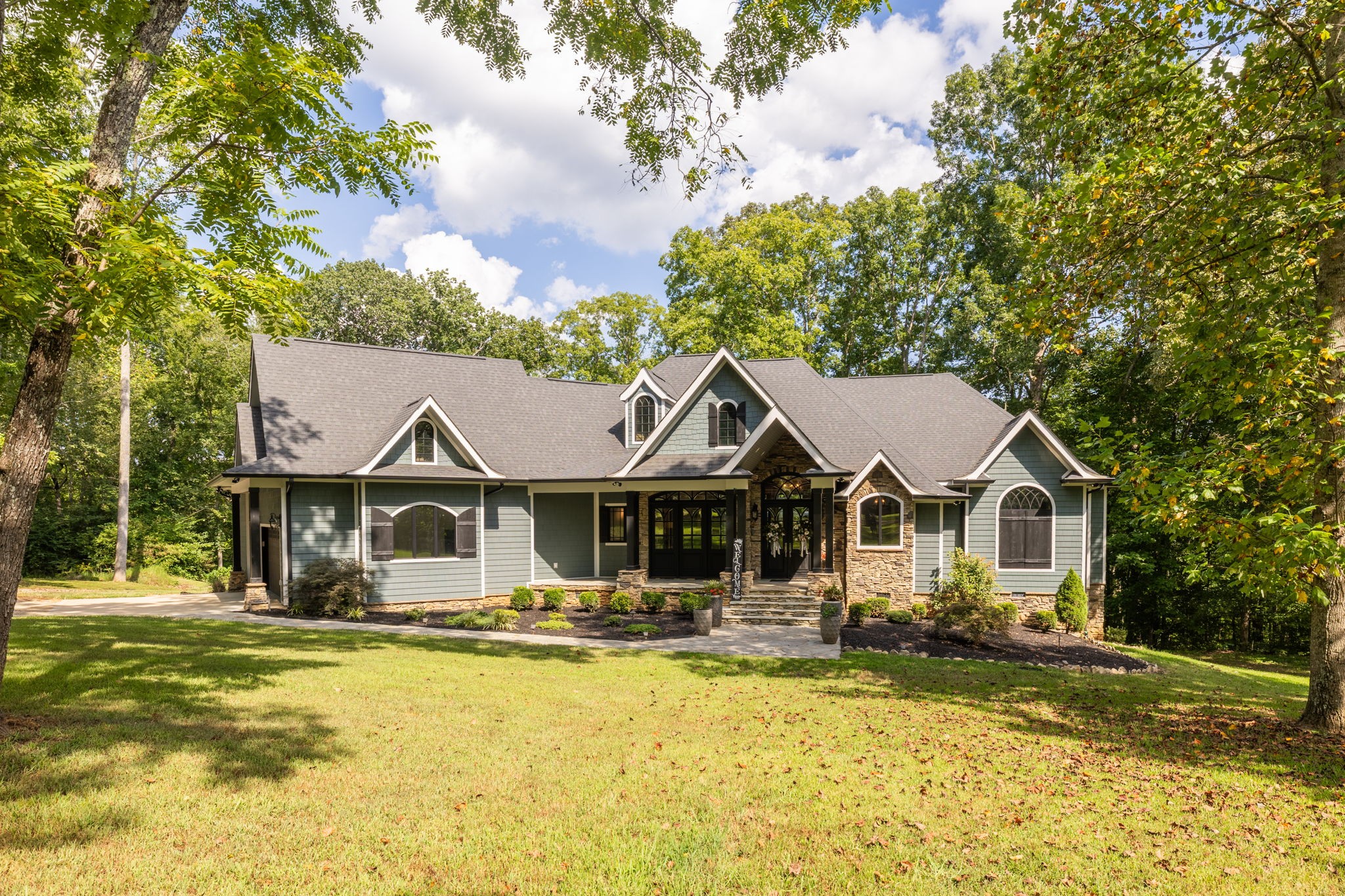 74 Pine Lake Road Summertown, TN 38483 - Photo 5 of 90 a front view of a house with a yard table and chairs