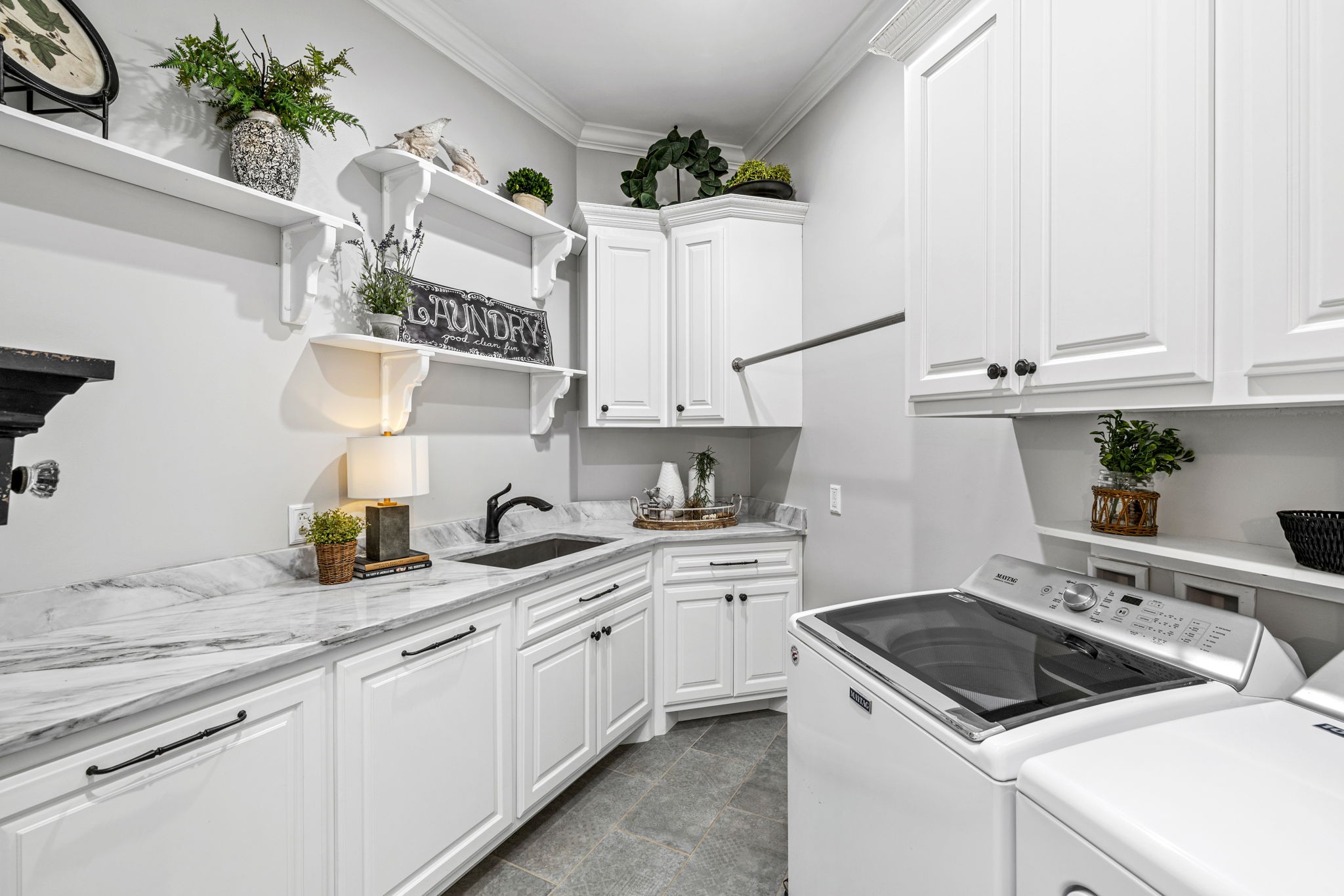 74 Pine Lake Road Summertown, TN 38483 - Photo 54 of 90 a kitchen with granite countertop a sink stainless steel appliances and white cabinets