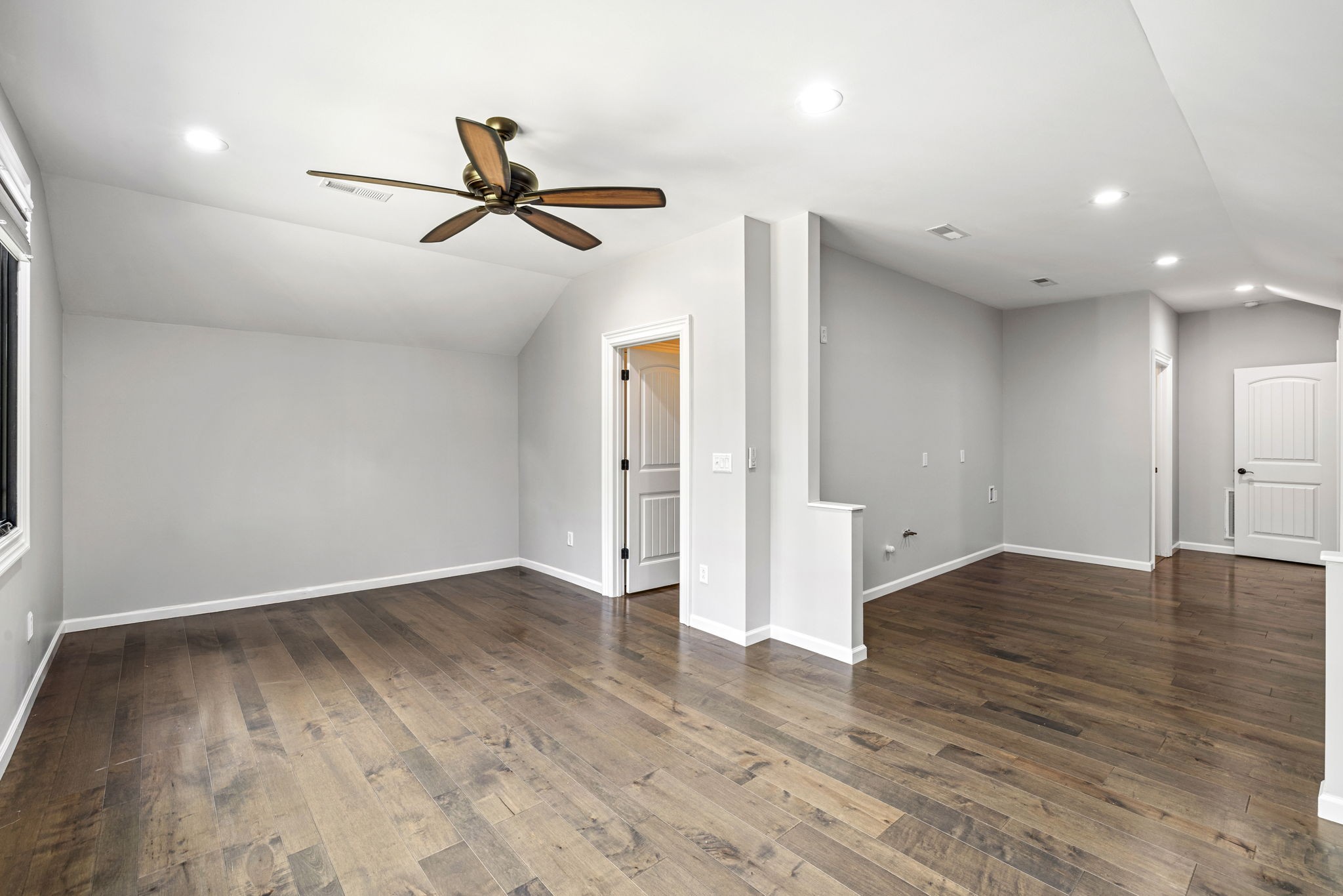 74 Pine Lake Road Summertown, TN 38483 - Photo 57 of 90 an empty room with wooden floor ceiling fan and windows