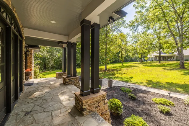 a living room with furniture a fireplace and a large window