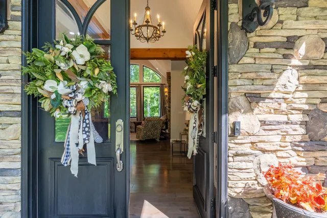 a living room with furniture a fireplace and large windows
