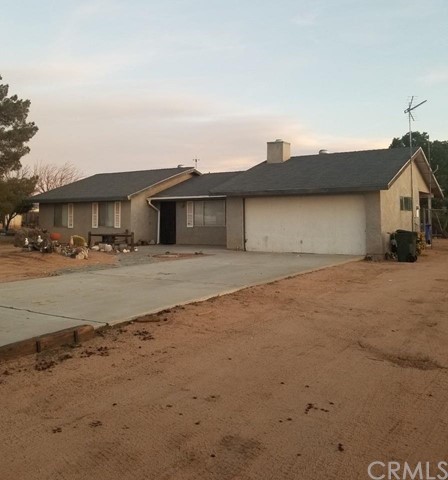 22763 El Centro Road Apple Valley, CA 92307 - Photo 1 of 1 a front view of a house with a yard