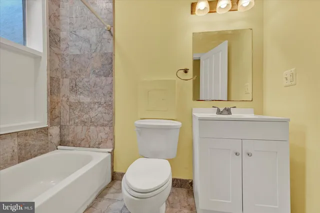 a bathroom with a sink a toilet and bathtub