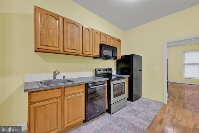 a kitchen with stainless steel appliances granite countertop a stove a sink dishwasher and a refrigerator