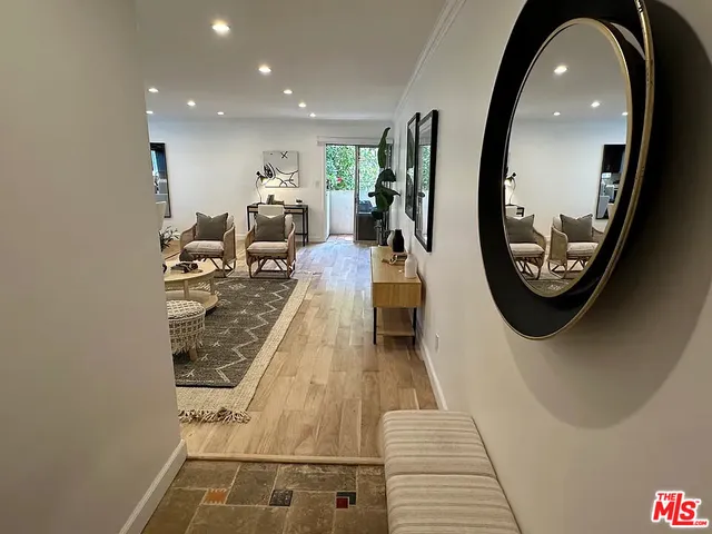 an entryway with furniture and a mirror