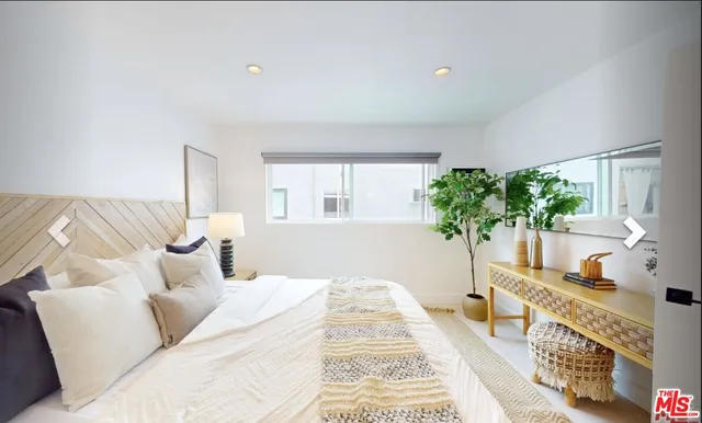 a bedroom with furniture and a potted plant