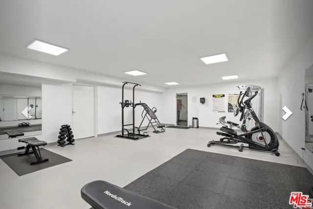 a view of a house with a window and potted plants