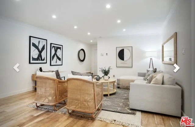 a living room with furniture and a large mirror