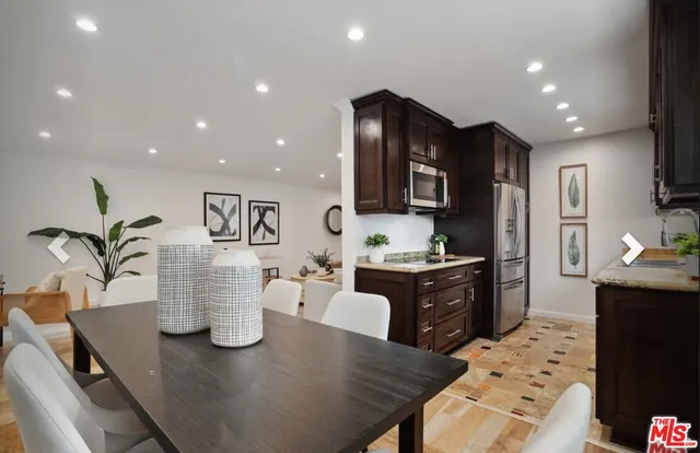 a kitchen with a refrigerator and a stove top oven