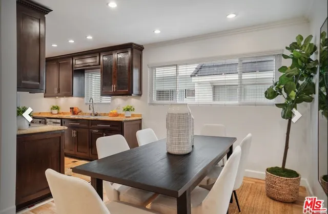 a view of a dining room with furniture and a potted plant
