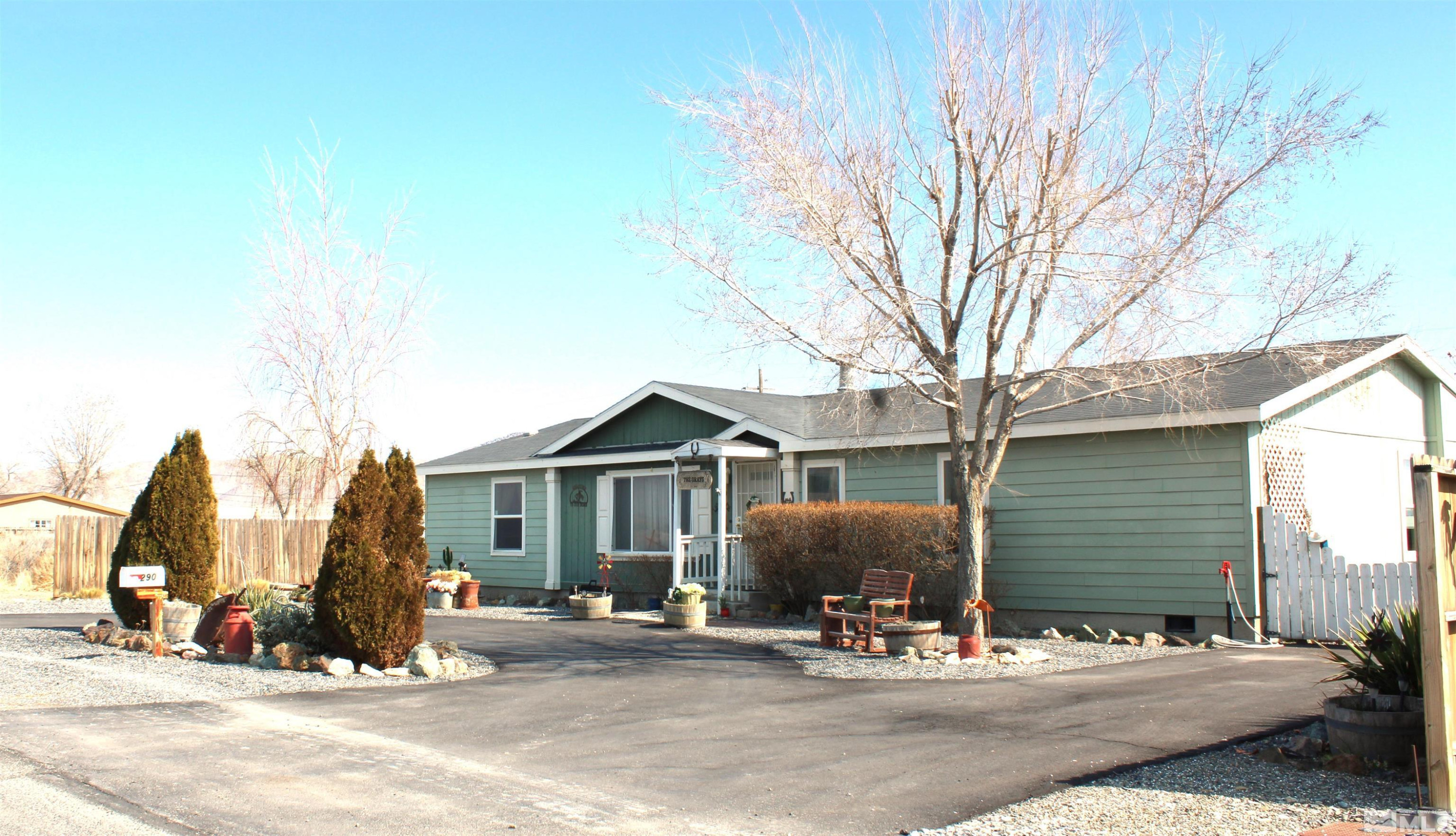 a front view of a house with outdoor seating