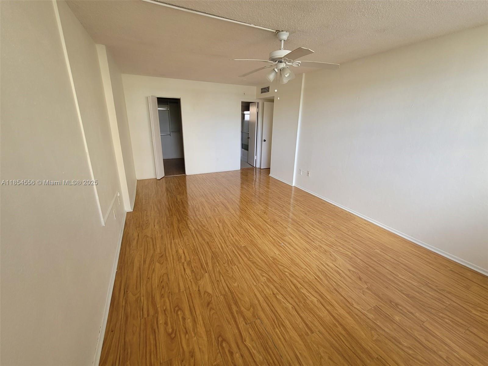 16400 Northeast 17th Avenue, Unit 206 North Miami Beach, FL 33162 - Photo 11 of 12 a view of a hallway with wooden floor