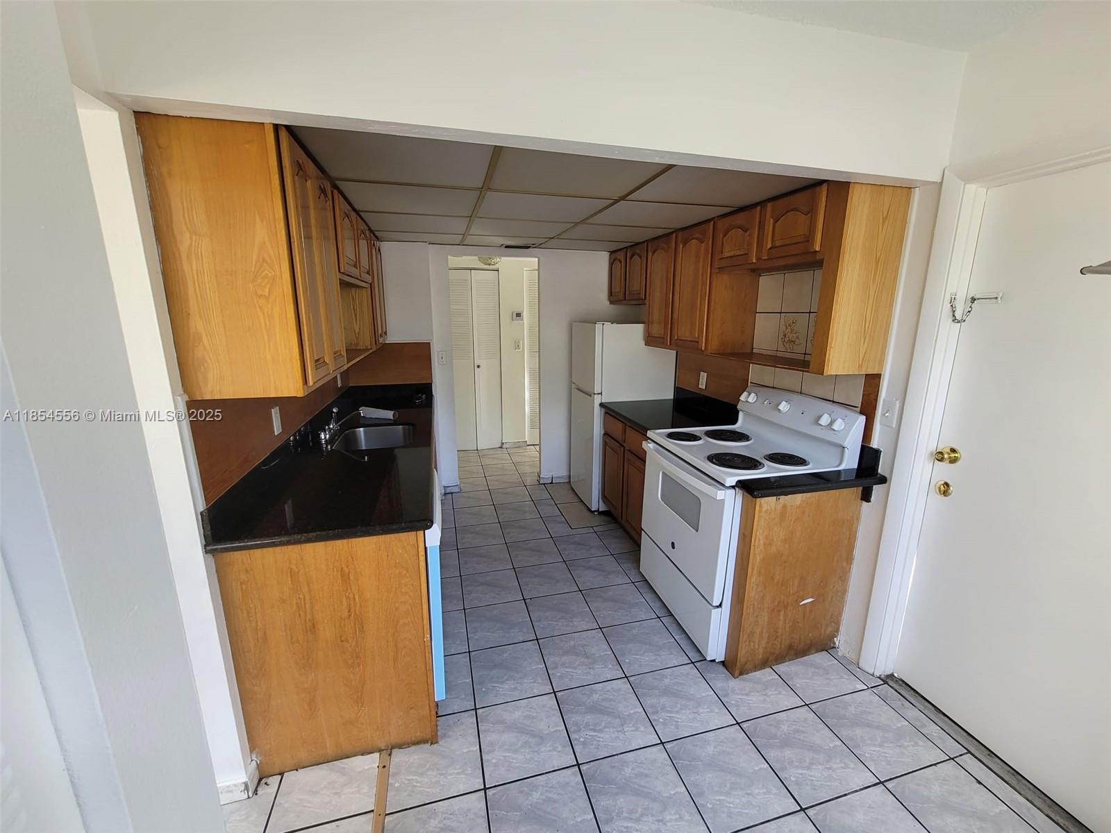 16400 Northeast 17th Avenue, Unit 206 North Miami Beach, FL 33162 - Photo 3 of 12 a kitchen with stainless steel appliances a stove a refrigerator a sink and cabinets