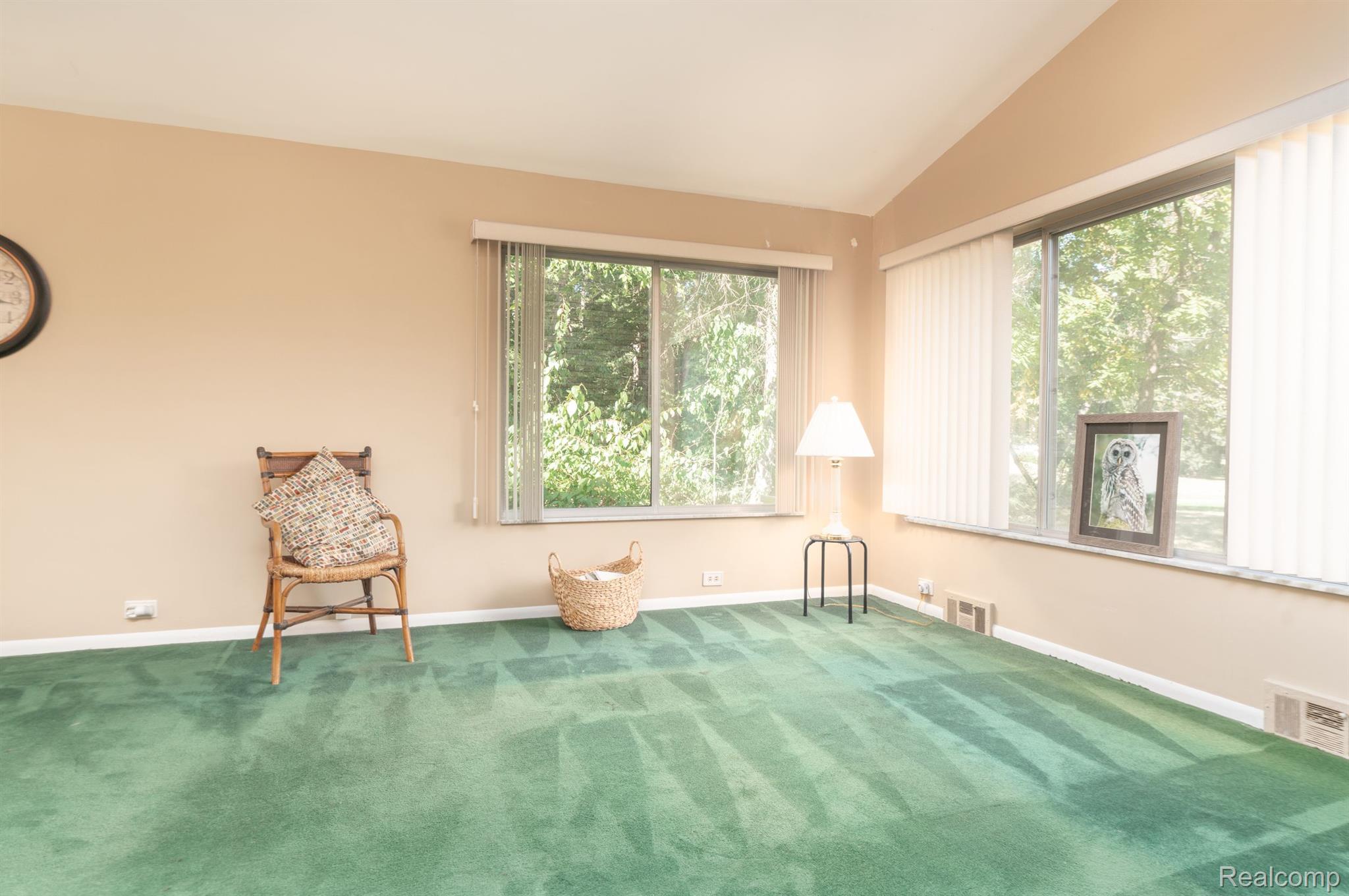 5044 Greenfield Road Brighton, MI 48114 - Photo 9 of 39 Living room w/ vaulted ceilings and large windows