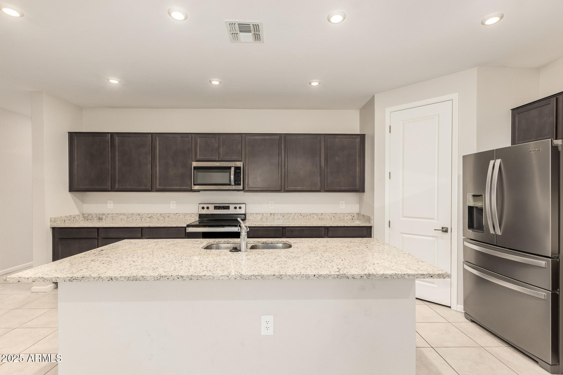 4677 South Siphon Draw Road Apache Junction, AZ 85119 - Photo 10 of 45 a kitchen with stainless steel appliances granite countertop a sink and a refrigerator