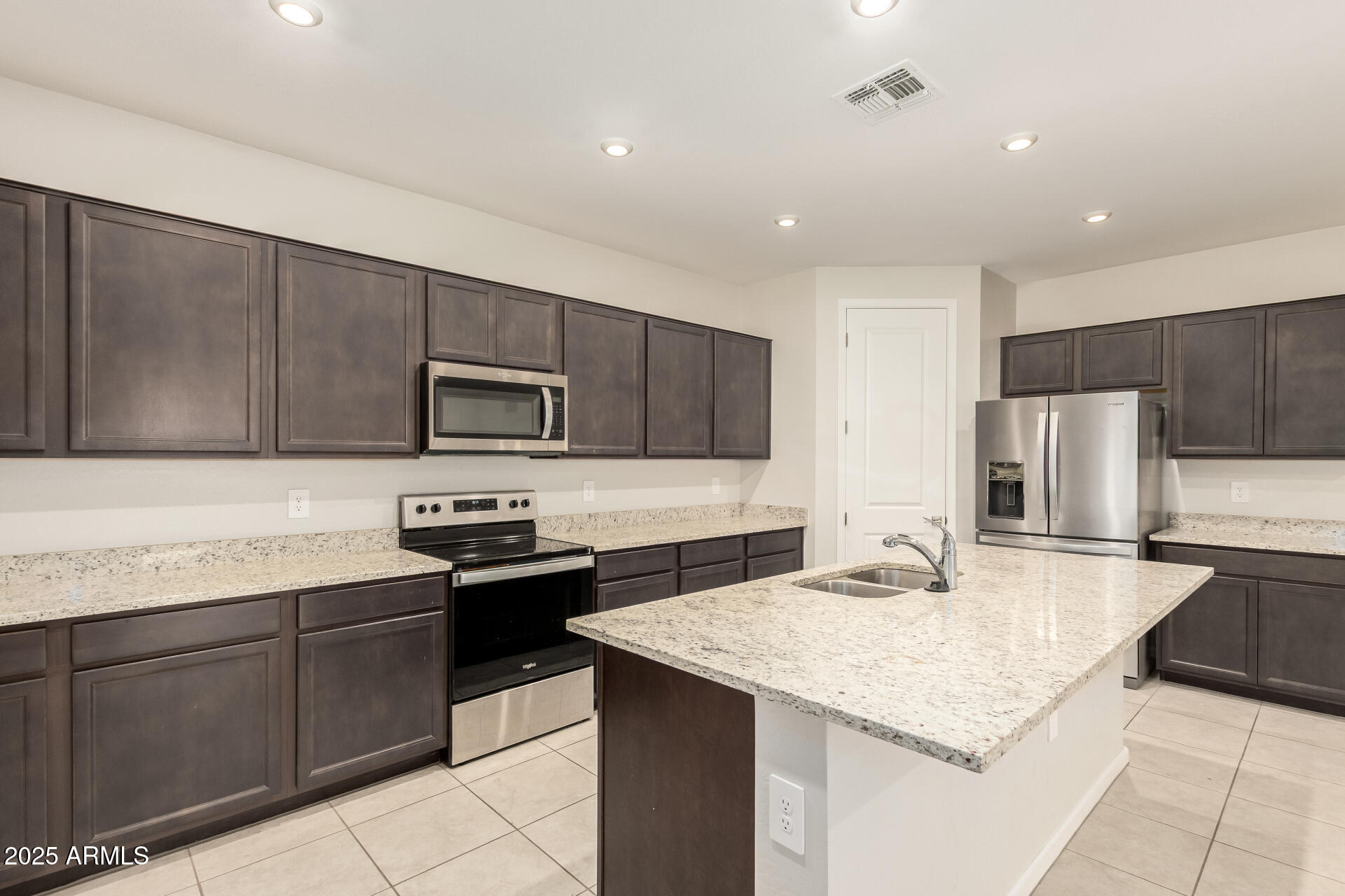4677 South Siphon Draw Road Apache Junction, AZ 85119 - Photo 11 of 45 a kitchen with stainless steel appliances granite countertop a sink stove and refrigerator