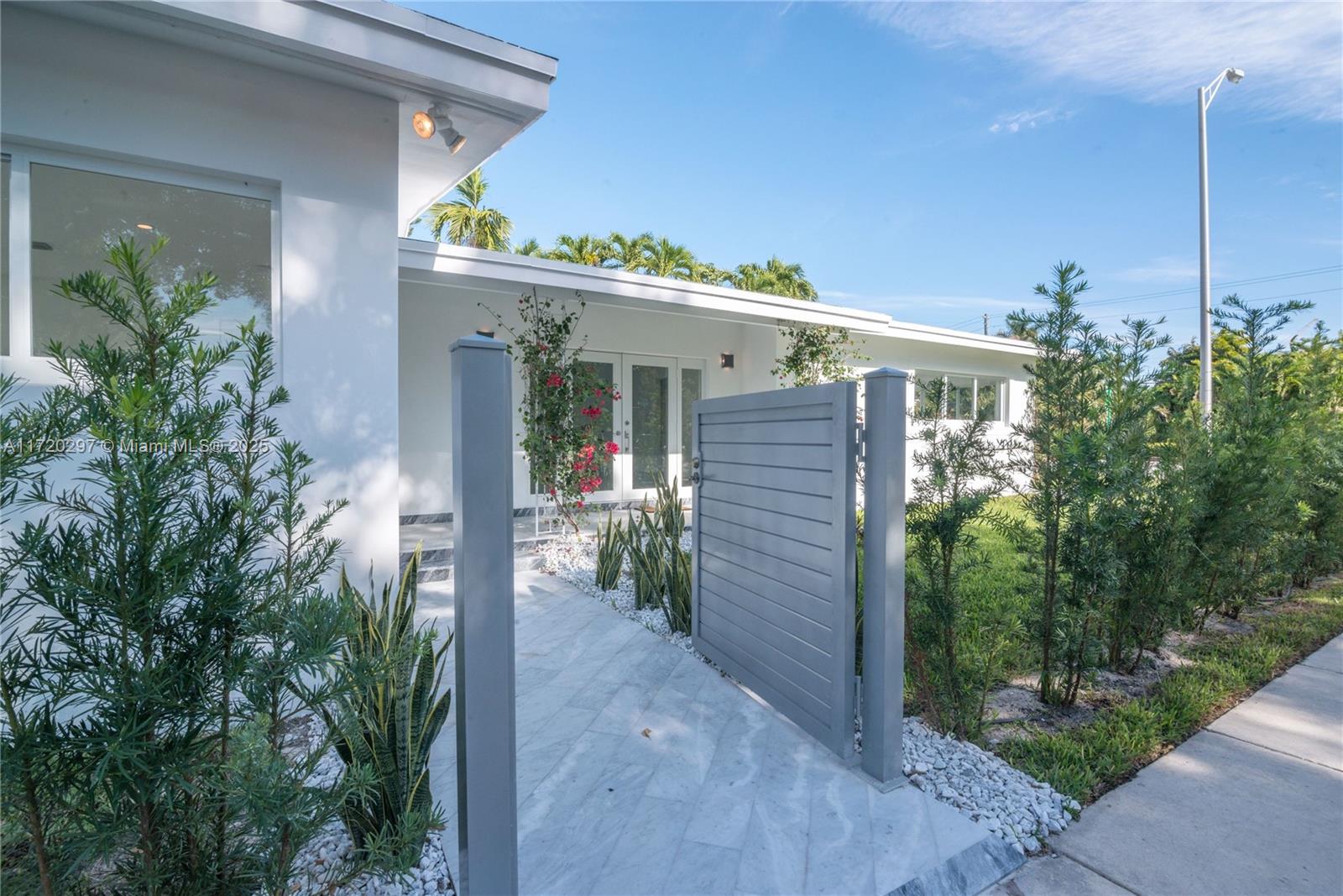 4500 Alton Road Miami Beach, FL 33140 - Photo 1 of 32 front view of a house with potted plants