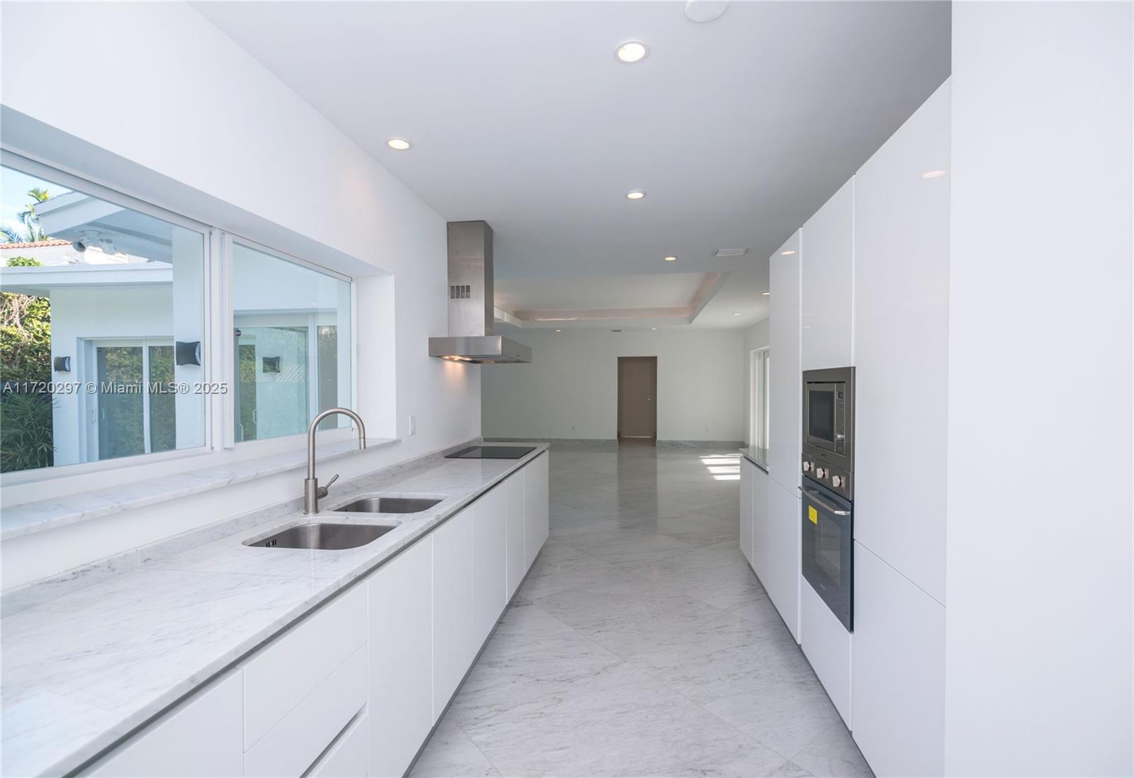 4500 Alton Road Miami Beach, FL 33140 - Photo 19 of 32 a kitchen with a sink and washing machine