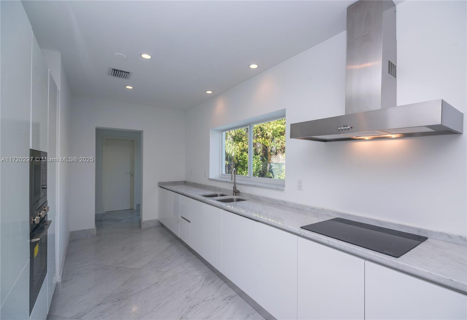 4500 Alton Road Miami Beach, FL 33140 - Photo 20 of 32 a kitchen with a sink and a window