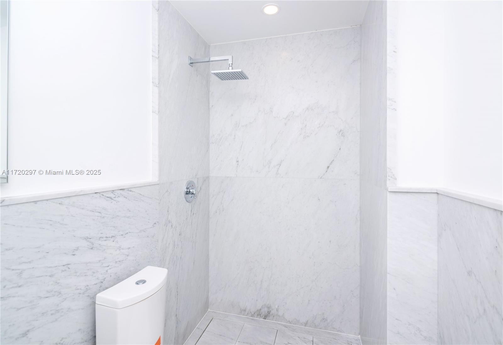 4500 Alton Road Miami Beach, FL 33140 - Photo 21 of 32 a white toilet sitting next to a white wall