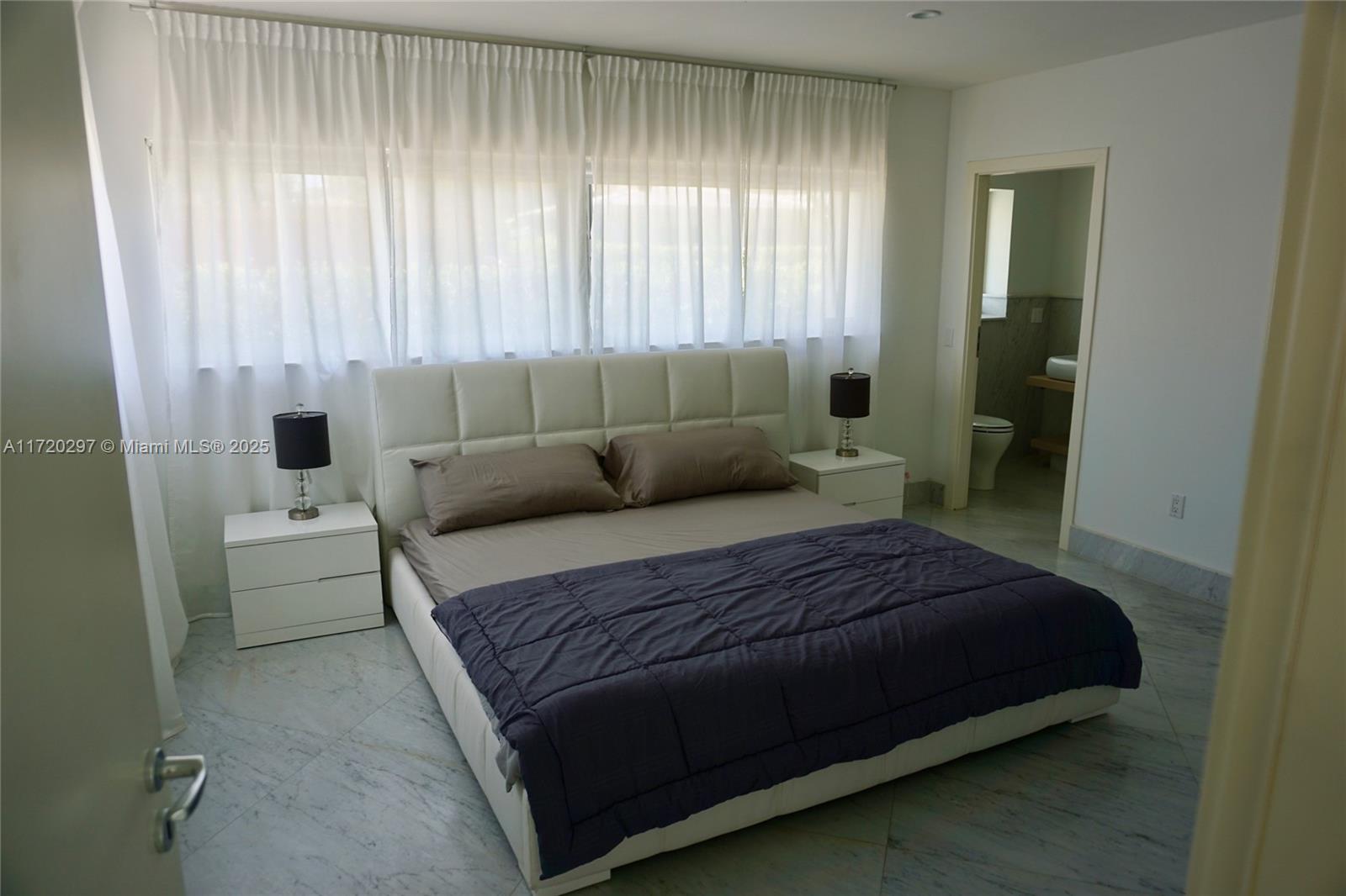 4500 Alton Road Miami Beach, FL 33140 - Photo 27 of 32 a bedroom with a bed and a window
