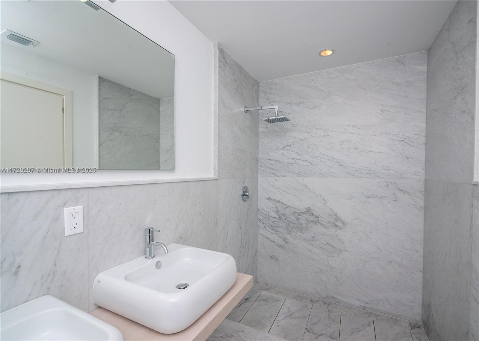 4500 Alton Road Miami Beach, FL 33140 - Photo 28 of 32 a bathroom with a sink and a mirror
