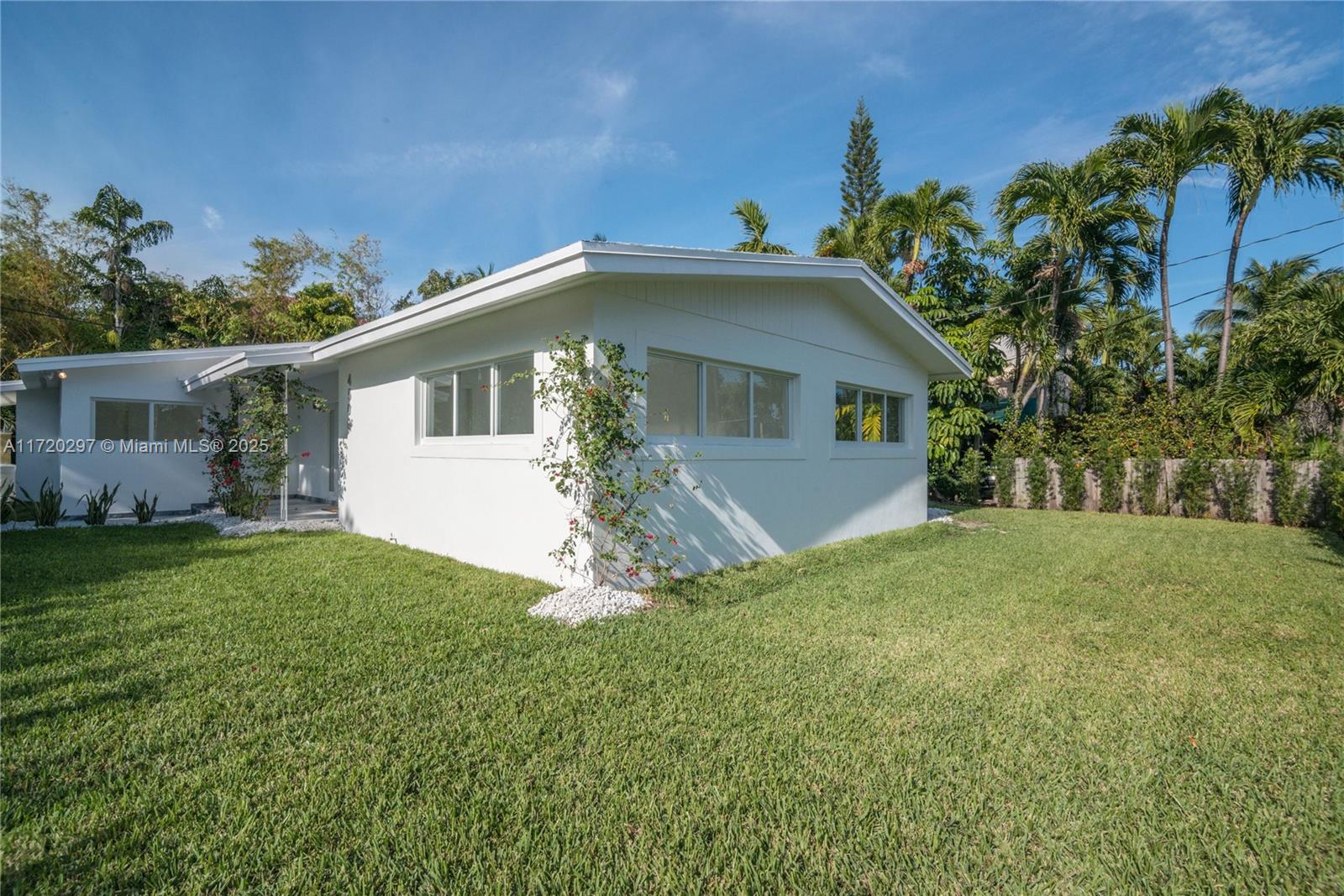 4500 Alton Road Miami Beach, FL 33140 - Photo 5 of 32 a front view of a house with a garden