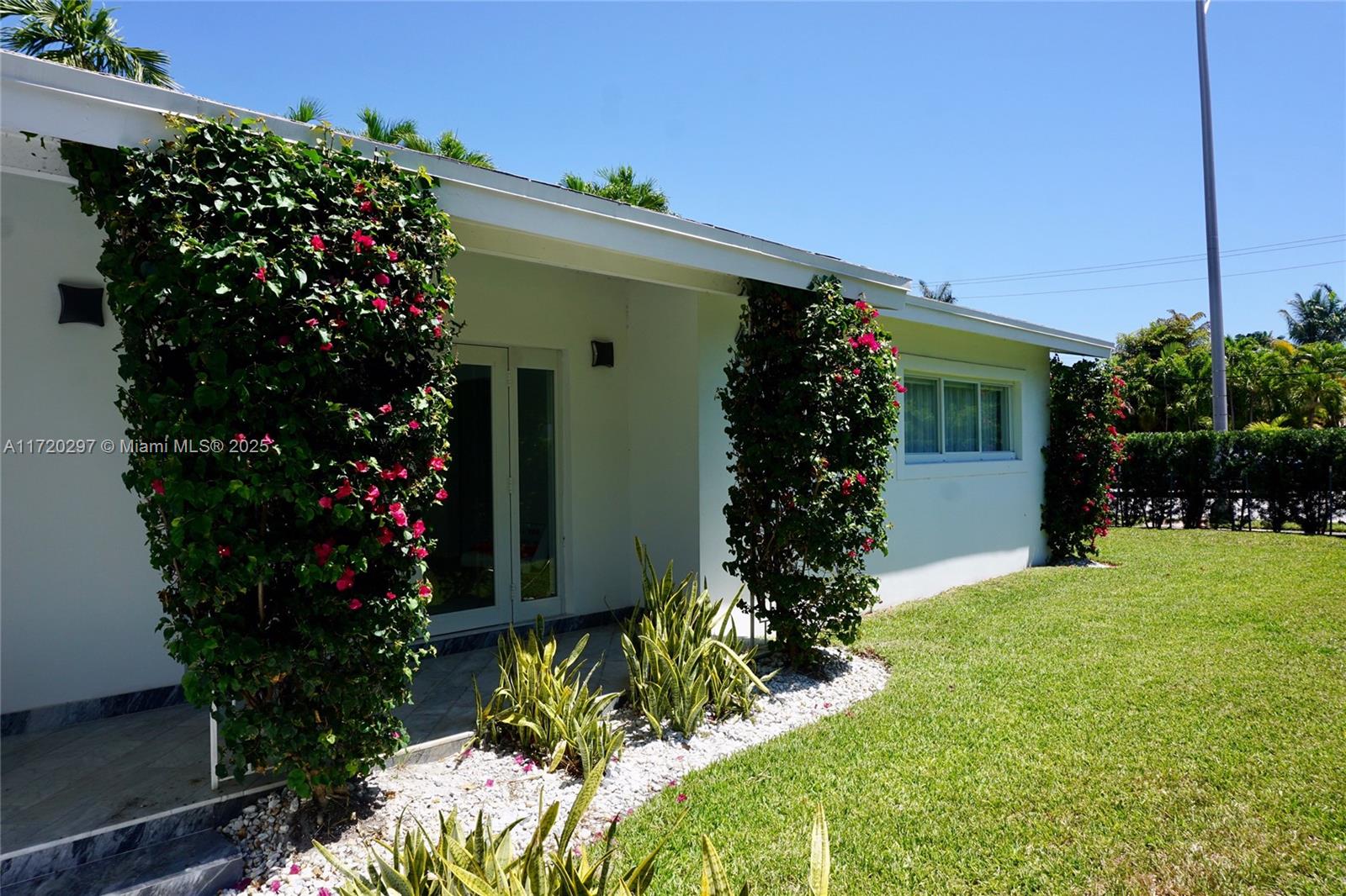 4500 Alton Road Miami Beach, FL 33140 - Photo 6 of 32 a view of a house with a backyard