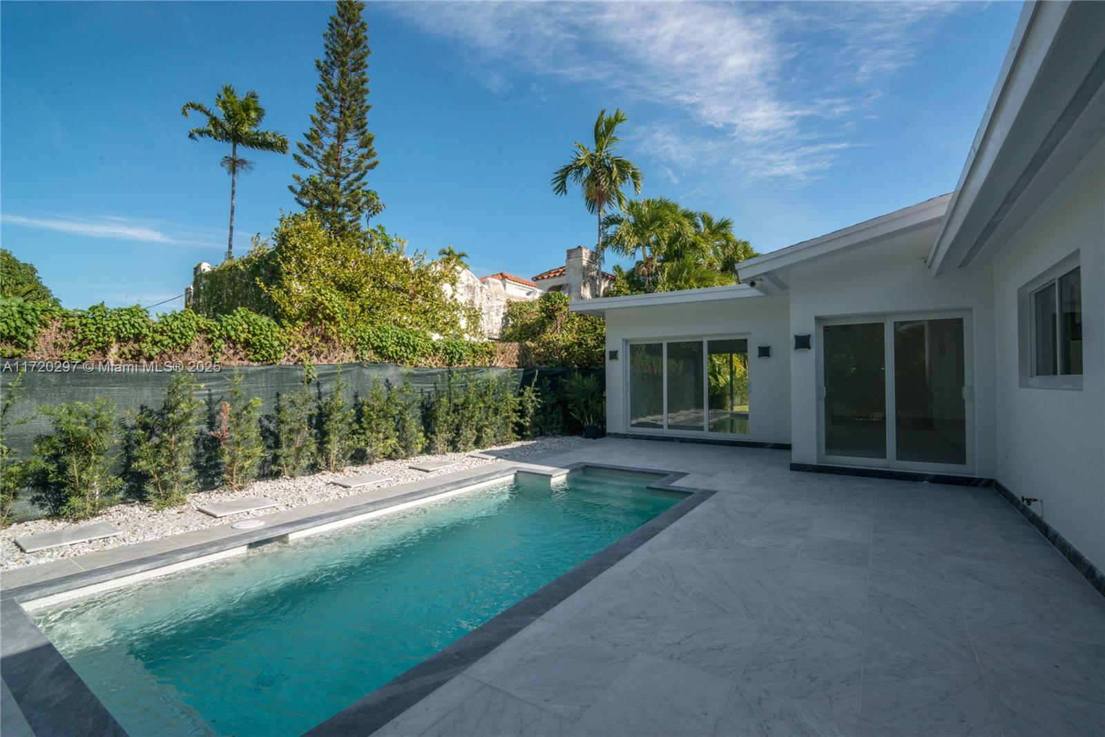 4500 Alton Road Miami Beach, FL 33140 - Photo 7 of 32 a view of a house with porch and a garden