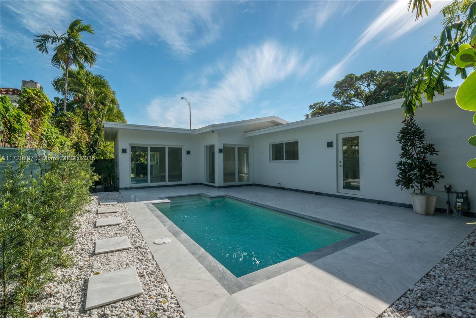 4500 Alton Road Miami Beach, FL 33140 - Photo 8 of 32 front view of a house with a garden