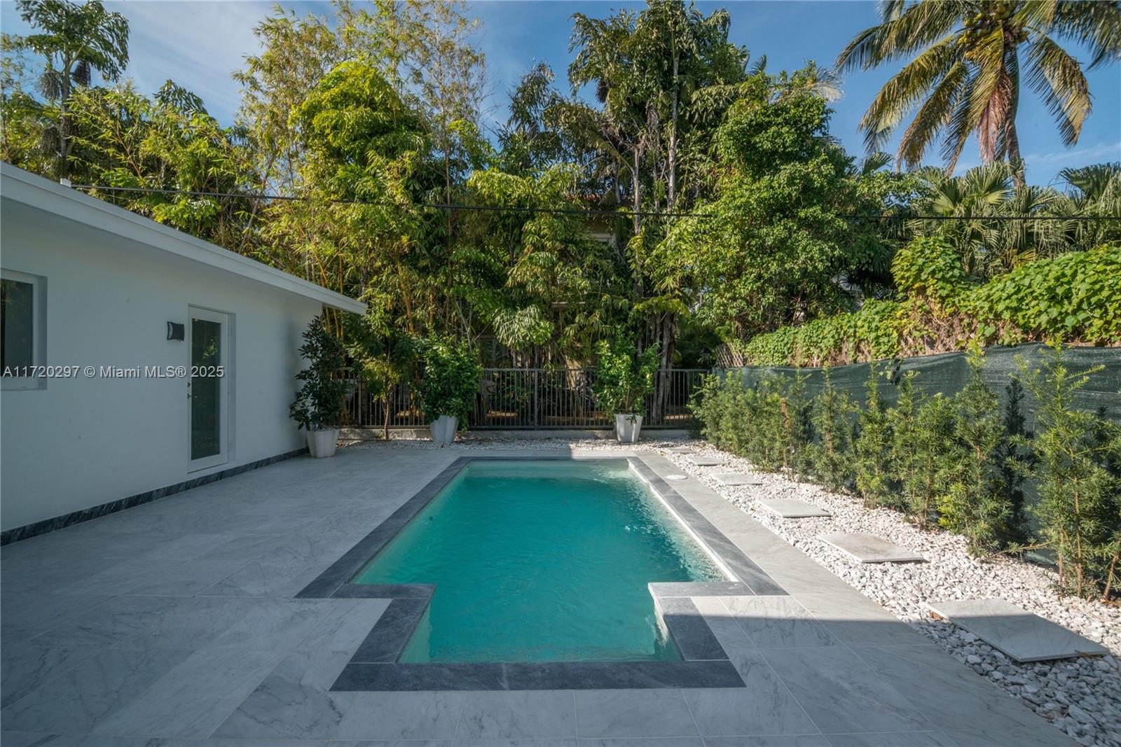 4500 Alton Road Miami Beach, FL 33140 - Photo 10 of 32 a view of a backyard with swimming pool