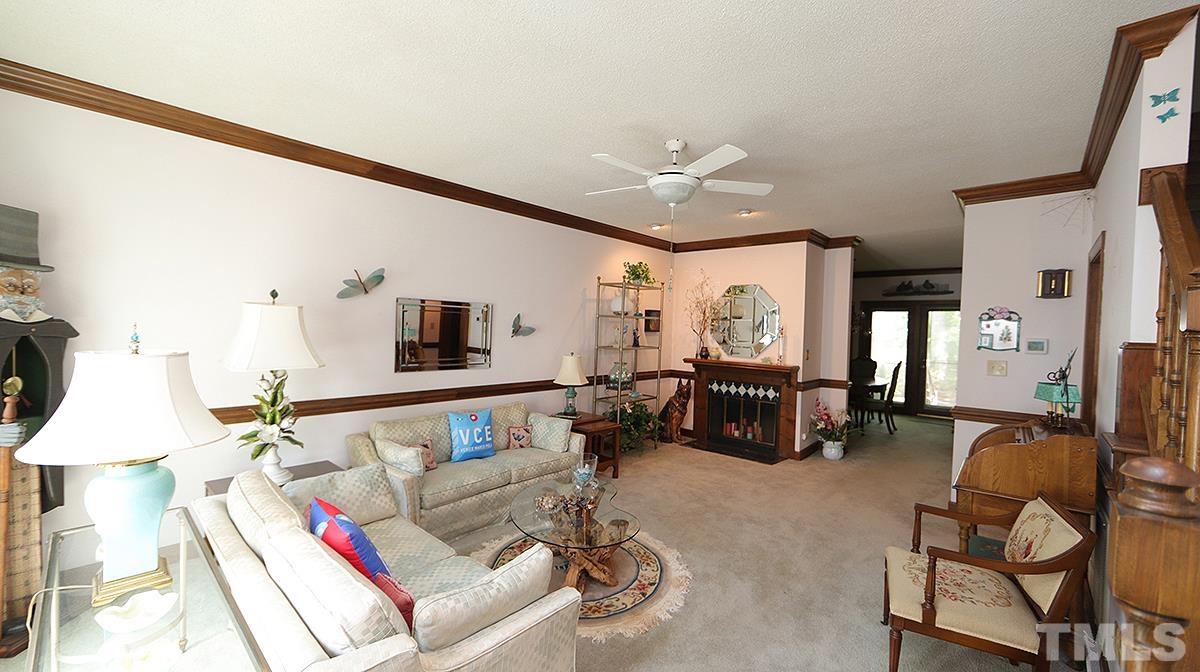 7943 Footman Way Raleigh, NC 27615 - Photo 2 of 11 a living room with furniture and a flat screen tv