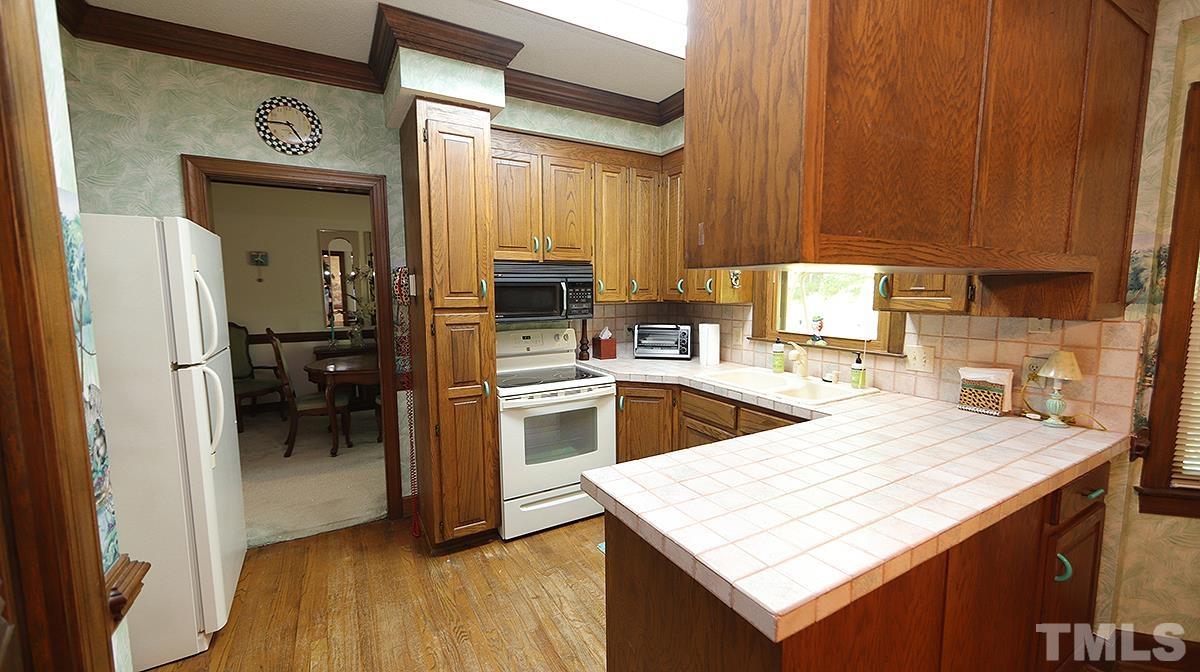 7943 Footman Way Raleigh, NC 27615 - Photo 5 of 11 a kitchen with granite countertop a sink counter top space and appliances