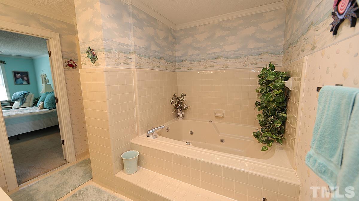 7943 Footman Way Raleigh, NC 27615 - Photo 10 of 11 a bathroom with a bathtub and shower